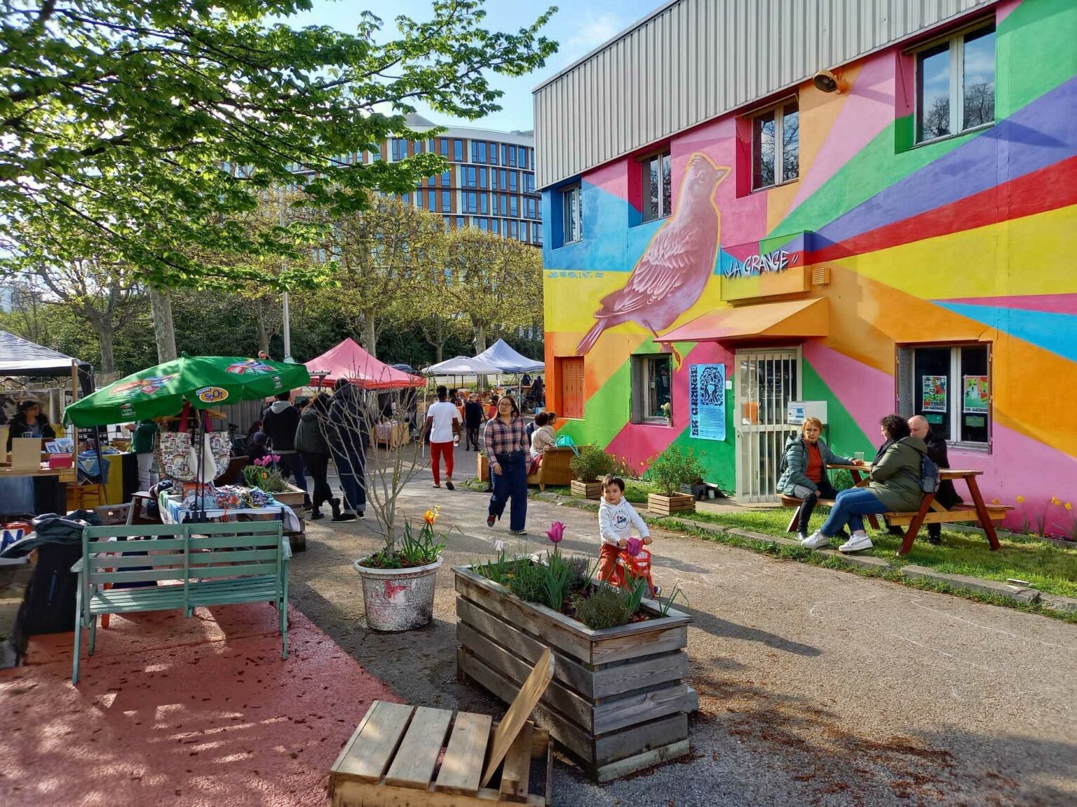 La Grange, des visiteurs sur la terrasse au soleil, tiers-lieu relevant de l'urbanisme transitoire - Plateau Urbain